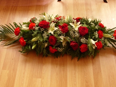 Red roses and carnations coffin spray