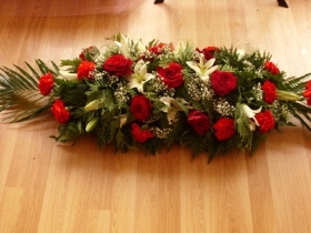 Red roses and carnations coffin spray